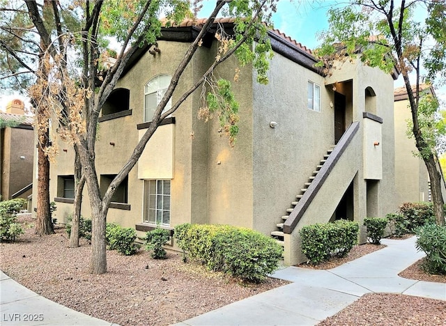 9000 S Las Vegas Blvd Unit 1187, Las Vegas, NV 89123 - view of property exterior featuring stucco siding, stairs, and a tiled roof