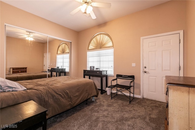 bedroom with ceiling fan, dark colored carpet, and baseboards