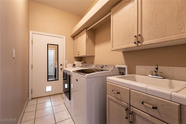 laundry room with light tile patterned floors, baseboards, washer and dryer, a sink, and cabinet space