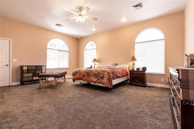 bedroom with dark carpet, visible vents, and baseboards