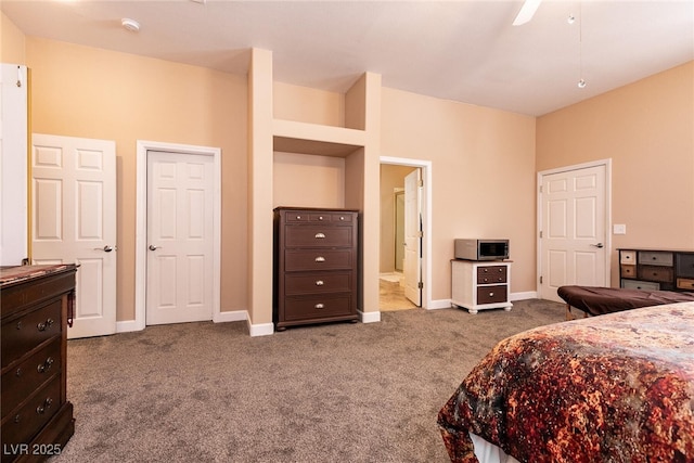 bedroom with ensuite bath, baseboards, and carpet