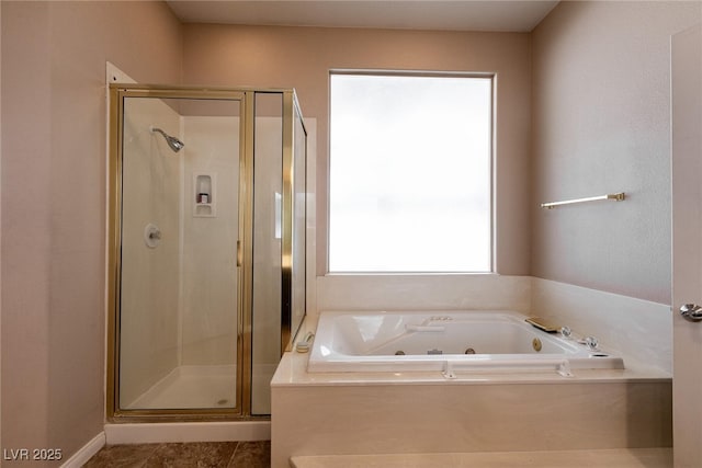 bathroom featuring a shower stall and a tub with jets