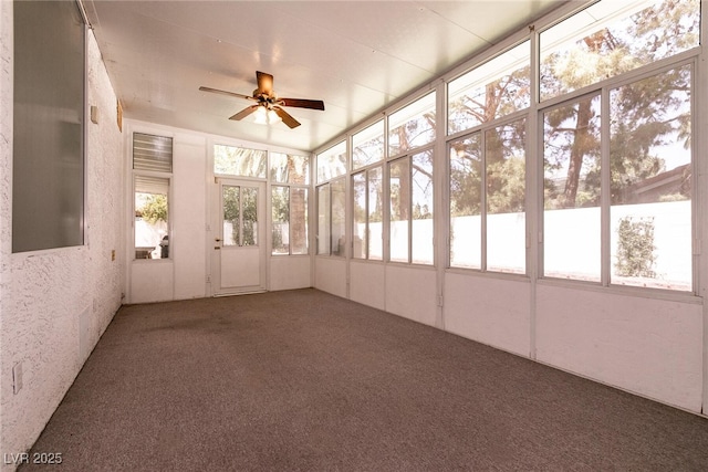 unfurnished sunroom featuring a ceiling fan