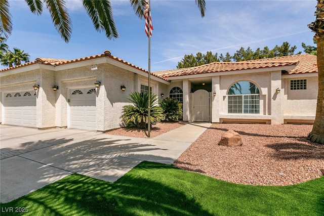 mediterranean / spanish-style home featuring a tile roof, driveway, a garage, and stucco siding