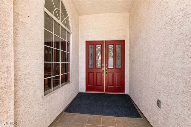 entrance to property with stucco siding