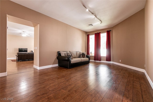 sitting room featuring visible vents, baseboards, rail lighting, and hardwood / wood-style flooring