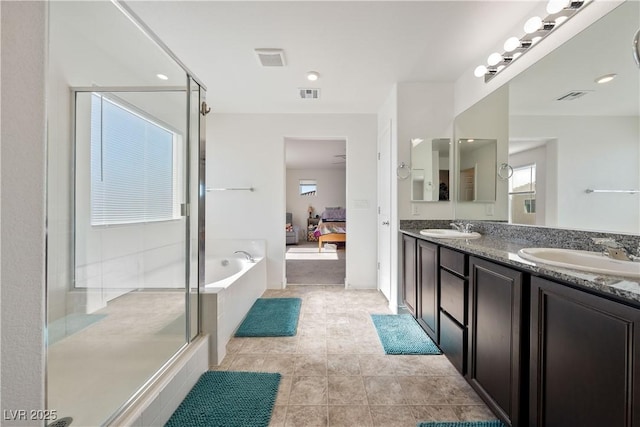 3981 E Teller Dr, Pahrump, NV 89061 - ensuite bathroom featuring a bath, a stall shower, double vanity, and tile patterned flooring