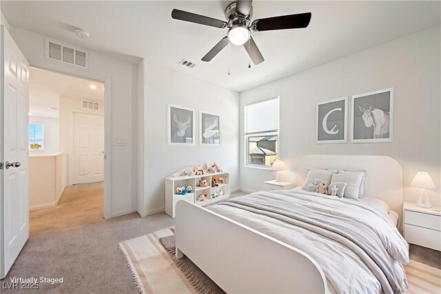 3981 E Teller Dr, Pahrump, NV 89061 - bedroom featuring light colored carpet, multiple windows, baseboards, and ceiling fan