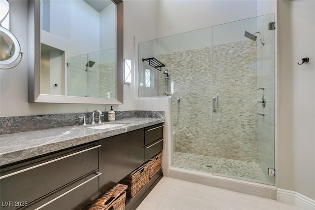 bathroom with tile patterned floors, a stall shower, and vanity