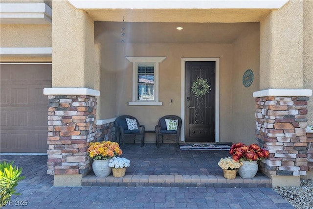 2833 Athena Hill Ct, Henderson, NV 89052 - property entrance with stucco siding, a garage, and stone siding