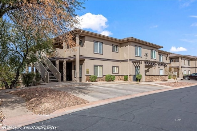 405 Paradise Pkwy Unit 170, Mesquite, NV 89027 - view of front of house featuring stone siding, stucco siding, and stairway