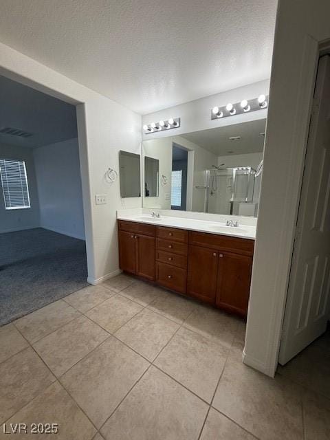 3104 Naggio Shores Ave, Las Vegas, NV 89141 - full bathroom featuring tile patterned floors, double vanity, and a shower stall