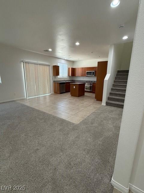3104 Naggio Shores Ave, Las Vegas, NV 89141 - kitchen featuring appliances with stainless steel finishes, open floor plan, a kitchen island, recessed lighting, and light colored carpet