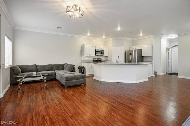 living room with visible vents, baseboards, dark wood-type flooring, and ornamental molding