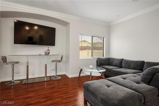 living area featuring wood finished floors, baseboards, and ornamental molding