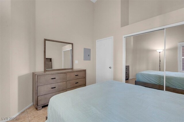 5000 Red Rock St Unit 241, Las Vegas, NV 89118 - bedroom with a towering ceiling, baseboards, a closet, and light tile patterned floors