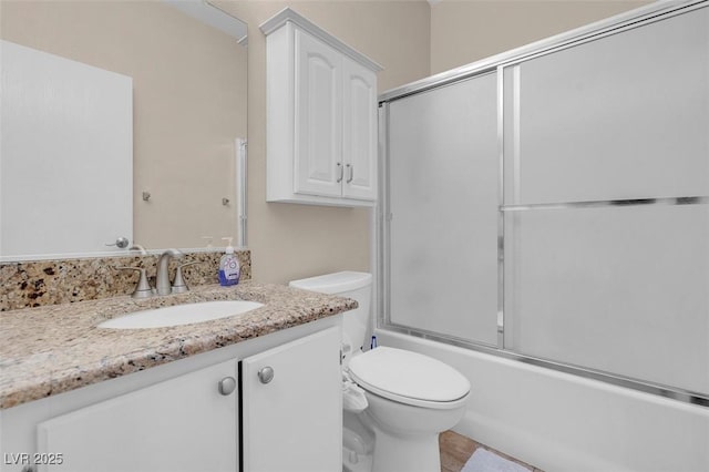 5000 Red Rock St Unit 241, Las Vegas, NV 89118 - bathroom featuring toilet, vanity, and combined bath / shower with glass door