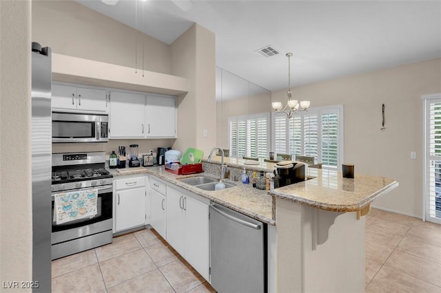 5000 Red Rock St Unit 241, Las Vegas, NV 89118 - kitchen featuring appliances with stainless steel finishes, a sink, light tile patterned floors, and a peninsula