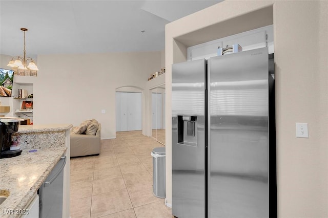 5000 Red Rock St Unit 241, Las Vegas, NV 89118 - kitchen featuring stainless steel appliances, light tile patterned floors, light stone countertops, a chandelier, and open floor plan