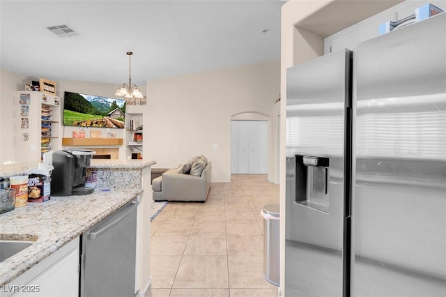 5000 Red Rock St Unit 241, Las Vegas, NV 89118 - kitchen with appliances with stainless steel finishes, a chandelier, light tile patterned floors, light stone counters, and white cabinets