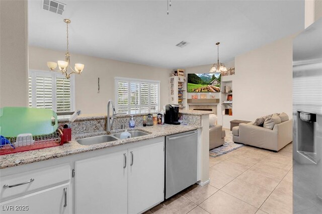 5000 Red Rock St Unit 241, Las Vegas, NV 89118 - kitchen featuring stainless steel dishwasher, a chandelier, a sink, light tile patterned floors, and white cabinetry