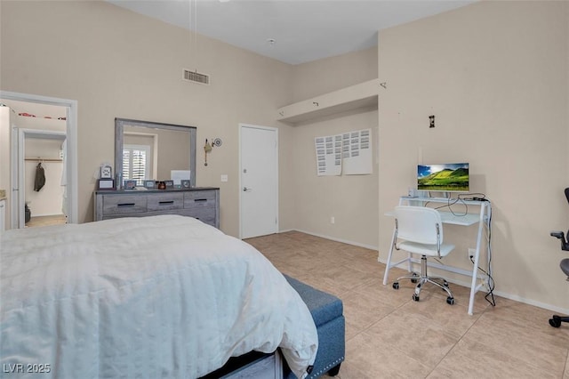 5000 Red Rock St Unit 241, Las Vegas, NV 89118 - bedroom featuring light tile patterned floors, a high ceiling, and baseboards