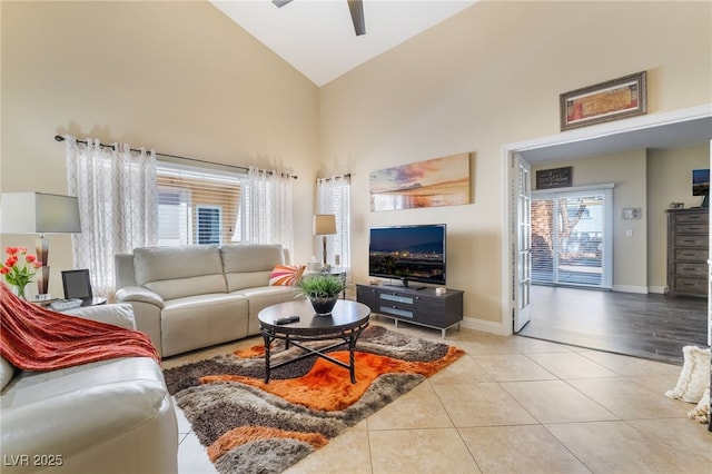 2246 Cassatt Dr, Henderson, NV 89074 - living room with light tile patterned floors, ceiling fan, high vaulted ceiling, and baseboards