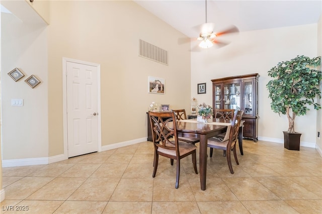 2246 Cassatt Dr, Henderson, NV 89074 - dining room featuring visible vents, baseboards, ceiling fan, light tile patterned floors, and a high ceiling