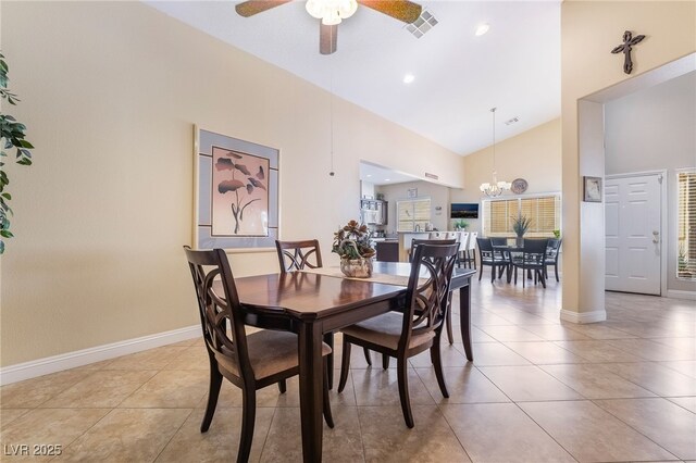 2246 Cassatt Dr, Henderson, NV 89074 - dining space featuring light tile patterned floors, baseboards, high vaulted ceiling, and ceiling fan with notable chandelier