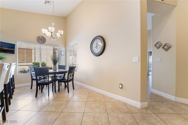 2246 Cassatt Dr, Henderson, NV 89074 - dining space with light tile patterned floors, visible vents, a notable chandelier, and a high ceiling