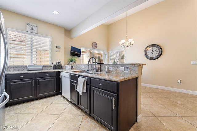 2246 Cassatt Dr, Henderson, NV 89074 - kitchen with a sink, an inviting chandelier, a peninsula, white dishwasher, and light tile patterned floors