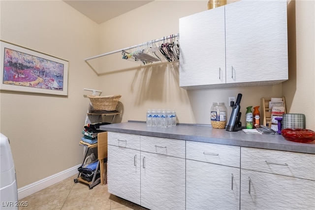 2246 Cassatt Dr, Henderson, NV 89074 - clothes washing area featuring light tile patterned floors, baseboards, and cabinet space