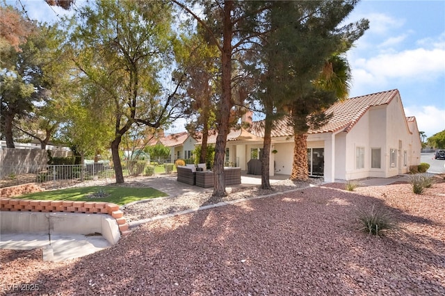 2246 Cassatt Dr, Henderson, NV 89074 - view of front of property with fence, stucco siding, a tile roof, a patio area, and an outdoor hangout area