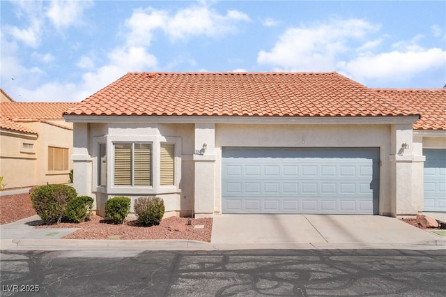 2246 Cassatt Dr, Henderson, NV 89074 - mediterranean / spanish house featuring a tiled roof, an attached garage, driveway, and stucco siding