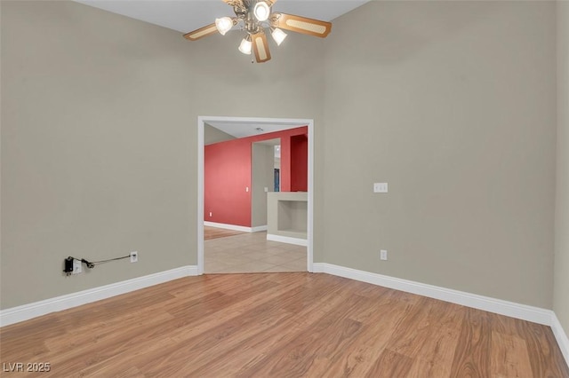 8217 Ashkum Ave, Las Vegas, NV 89149 - unfurnished room with a ceiling fan, baseboards, and light wood-style flooring