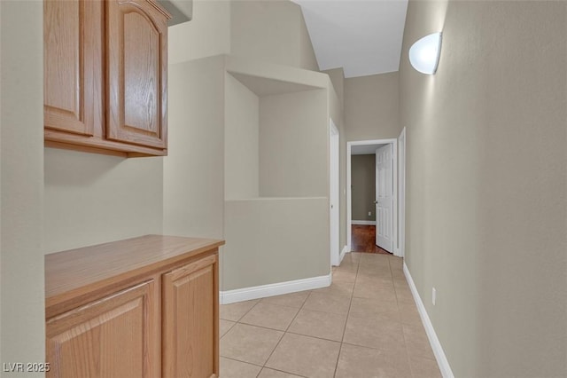 8217 Ashkum Ave, Las Vegas, NV 89149 - hallway with light tile patterned floors and baseboards