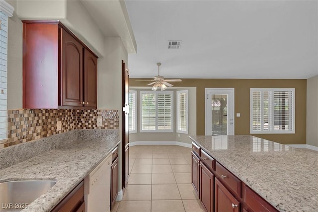8217 Ashkum Ave, Las Vegas, NV 89149 - kitchen featuring light stone counters, light tile patterned flooring, dishwasher, and baseboards