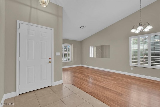 8217 Ashkum Ave, Las Vegas, NV 89149 - entrance foyer with a chandelier, light tile patterned flooring, baseboards, and high vaulted ceiling