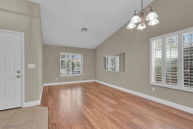 8217 Ashkum Ave, Las Vegas, NV 89149 - foyer featuring a chandelier, baseboards, light wood finished floors, and high vaulted ceiling