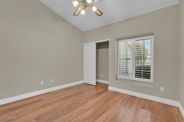 8217 Ashkum Ave, Las Vegas, NV 89149 - unfurnished bedroom featuring baseboards, light wood-style flooring, vaulted ceiling, a closet, and a ceiling fan