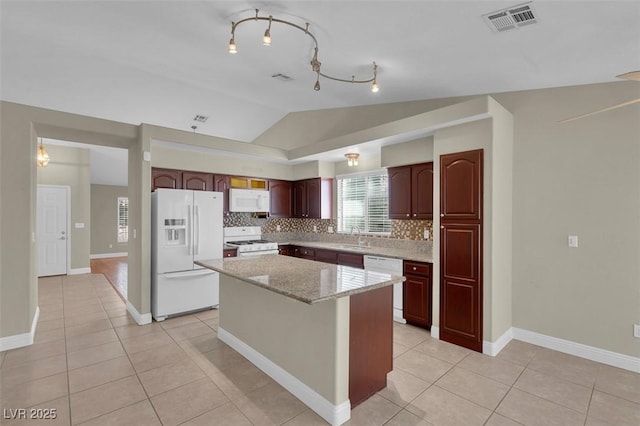 8217 Ashkum Ave, Las Vegas, NV 89149 - kitchen with white appliances, lofted ceiling, backsplash, a sink, and a center island