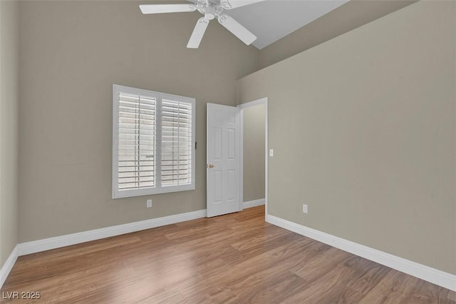8217 Ashkum Ave, Las Vegas, NV 89149 - spare room featuring baseboards, high vaulted ceiling, wood finished floors, and a ceiling fan