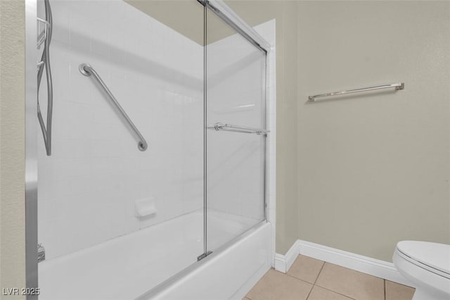 8217 Ashkum Ave, Las Vegas, NV 89149 - full bathroom featuring toilet, tile patterned flooring, enclosed tub / shower combo, and baseboards