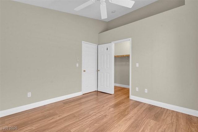 8217 Ashkum Ave, Las Vegas, NV 89149 - unfurnished bedroom with baseboards, light wood-type flooring, a spacious closet, a closet, and a ceiling fan