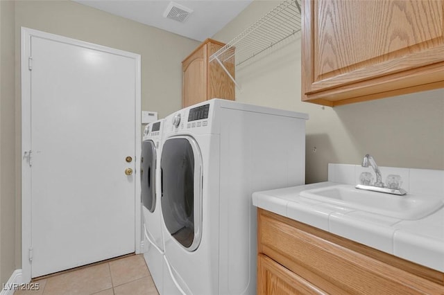 8217 Ashkum Ave, Las Vegas, NV 89149 - washroom with washer and dryer, cabinet space, and light tile patterned floors