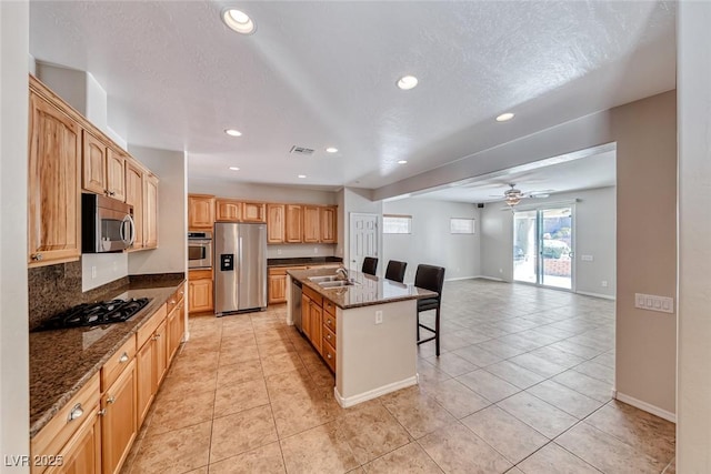 2528 Flodden St, Henderson, NV 89044 - kitchen with open floor plan, ceiling fan, appliances with stainless steel finishes, a breakfast bar, and recessed lighting
