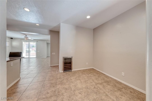 2528 Flodden St, Henderson, NV 89044 - unfurnished room featuring baseboards, recessed lighting, a ceiling fan, light tile patterned flooring, and wine cooler