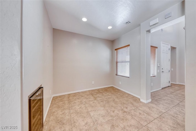 2528 Flodden St, Henderson, NV 89044 - empty room featuring light tile patterned floors, beverage cooler, visible vents, and recessed lighting