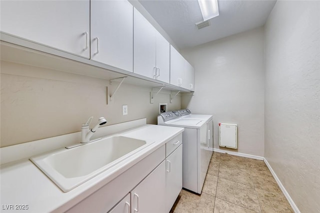 2528 Flodden St, Henderson, NV 89044 - washroom with baseboards, a sink, visible vents, cabinet space, and washing machine and clothes dryer