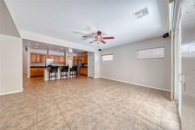 2528 Flodden St, Henderson, NV 89044 - living area featuring light tile patterned floors, visible vents, baseboards, and a ceiling fan